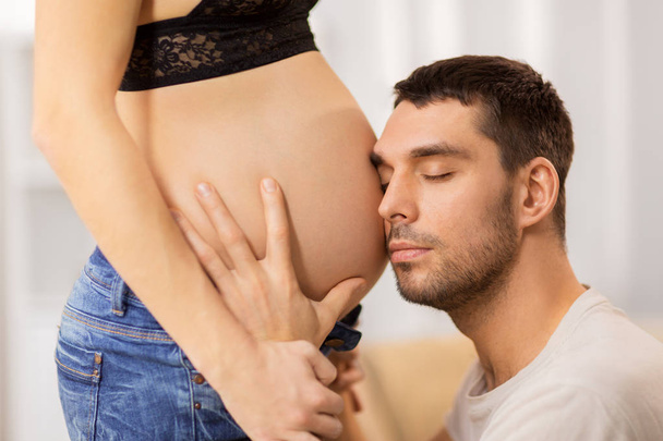 happy man touching pregnant woman belly - Фото, изображение