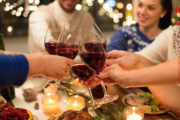 close up of friends with wine celebrate christmas - Foto, imagen
