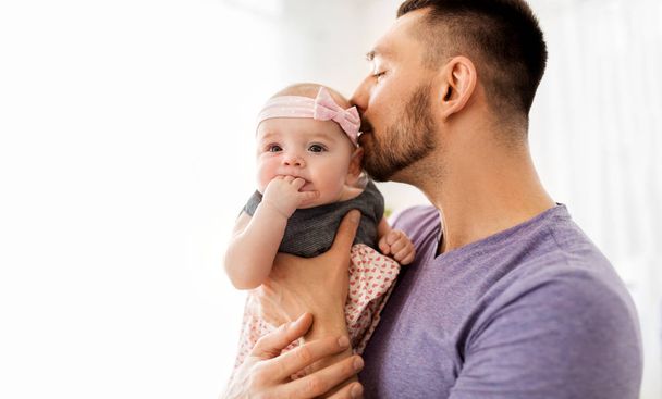 close up of father kissing little baby daughter - Φωτογραφία, εικόνα