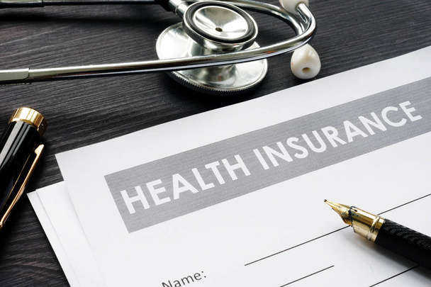 Health insurance policy, stethoscope and pen. - Fotografie, Obrázek
