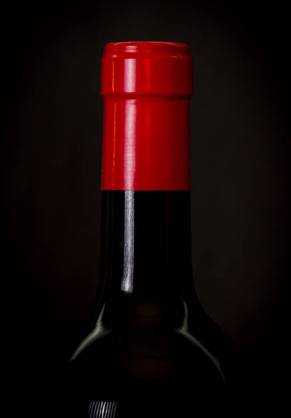 Wine bottle over black background - Foto, imagen