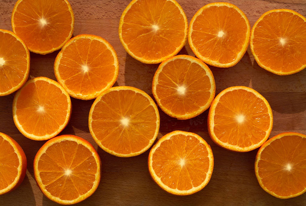 Citrus oranges slices background pattern on wooden table - Photo, image
