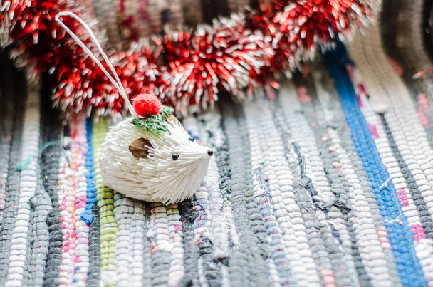 Noel oyuncak beyaz kirpi kırmızı çelenk closeup ile - Fotoğraf, Görsel
