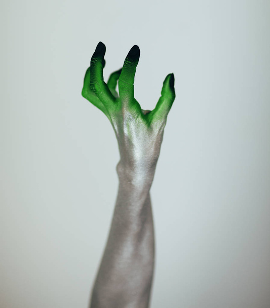 Creepy Halloween monster witch hand with white, green and black in front of white background - Foto, immagini