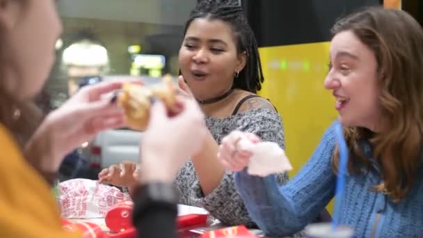 4k ultra hd dvě mladé ženy multietnický krytý jíst na fast food-food a nápoje, zákazník, společenské setkání koncept - Záběry, video