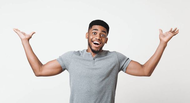 Excited african-american man raising his hands in happiness - Фото, изображение
