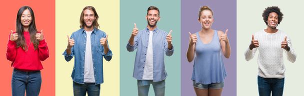 Composition of african american, hispanic and chinese group of people over vintage color background success sign doing positive gesture with hand, thumbs up smiling and happy. Looking at the camera with cheerful expression, winner gesture. - Foto, Bild