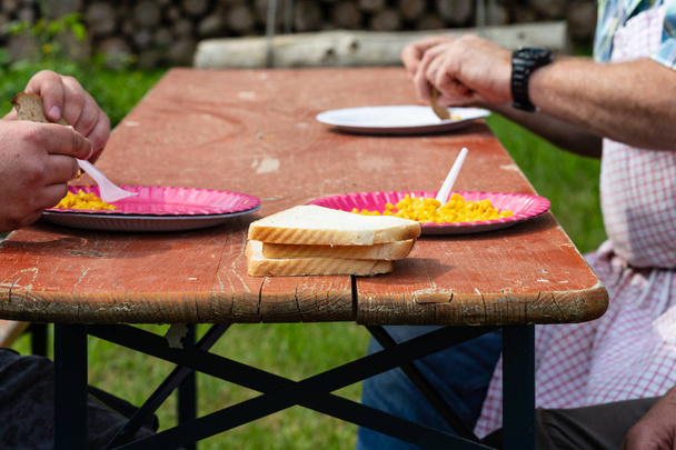 Men eating scrambled eggs on barbeque in southern Germany - Φωτογραφία, εικόνα