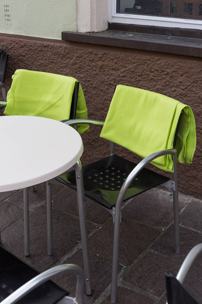 cafe bistro table chairs seating on a holiday springtime afternoon in south germany historical city - Photo, Image