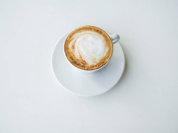 White Cup of cappuccino on a white table. - 写真・画像