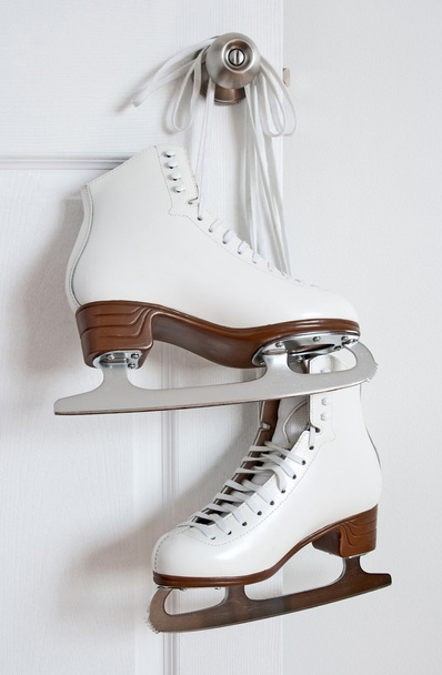 Figure skates hanging on a door knob - Photo, Image