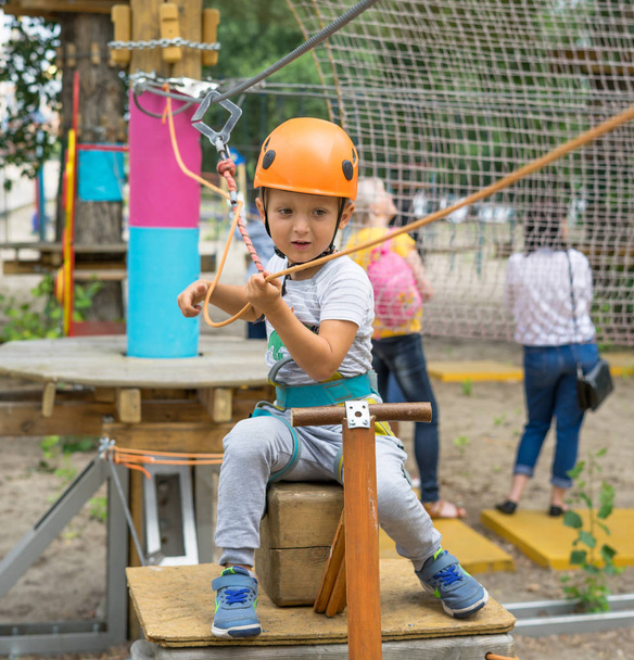 Boy at climbing activity in high wire forest park. Table Mountain Cableway kids special on again. - 写真・画像