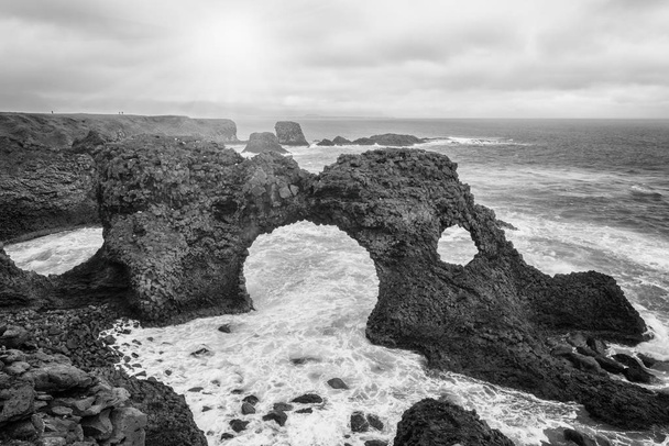 Amazing seascape, Gatklettur basalt rock arch at the volcanic cliff, Atlantic coast of Arnarstapi in the west of Iceland, natural travel background. Arnarstapi, Snaefellsnes peninsula, Iceland, Europe - Photo, Image