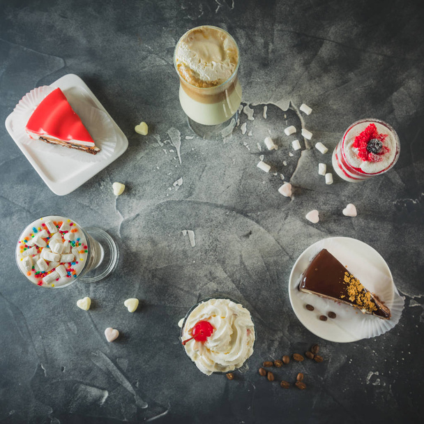 Food frame with milkshake drinks and desserts. Milkshakes and cake. Flat lay - 写真・画像