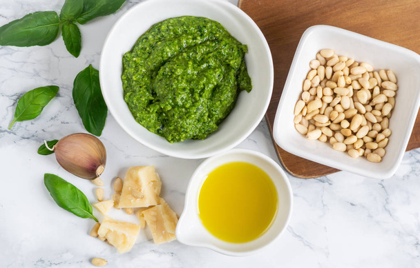 Homemade Classic Pesto Sauce in While Bowl with Pine Nuts Parmesan Cheese Garlic Olive Oil Healthy Food Concept - Foto, Imagem
