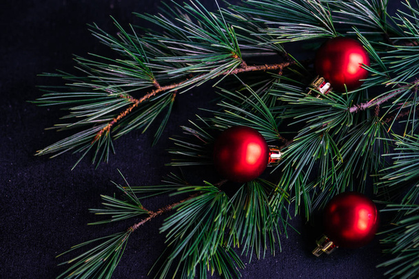 Festive Christmas frame with balls and fir tree on dark wooden background with copy space - Photo, Image