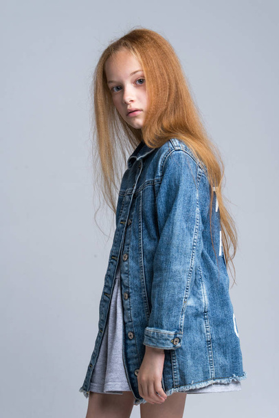 Portrait of beautiful young redhead girl posing in studio - Foto, Imagen
