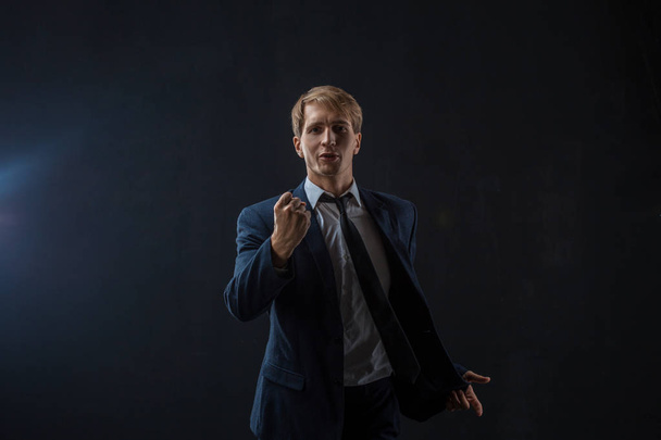 An ambitious Businessman speaks to you, motivational speaker on a black background. - Фото, изображение