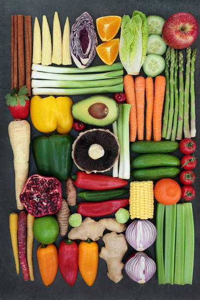 Vegetarian super food concept with fresh vegetables, fruit, herbs and spices. Health foods high in antioxidants, anthocyanins, vitamins and dietary fibre. Top view. - Photo, Image