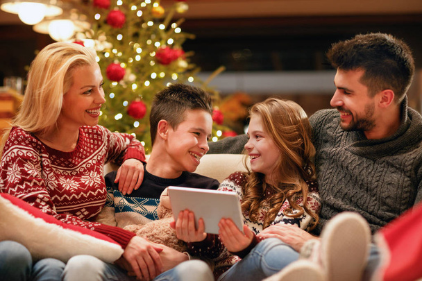 modern family having fun on digital tablet for Christmas time - Foto, Imagem