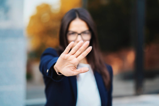 Portrait of young businesswoman disapproval gesture with hand: denial sign, no sign, negative gesture, professional female manager wearing glasses and suit. - Foto, afbeelding