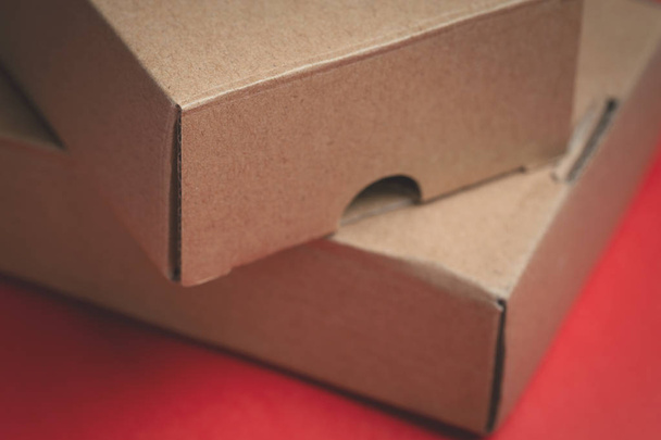 close up of small cardboard packs in red background - Foto, imagen