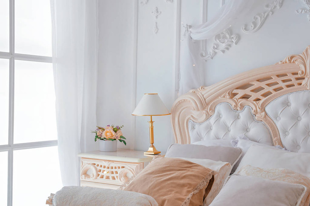 Closeup of Bright White Bedroom Iterior with night table lamp and window - Photo, Image