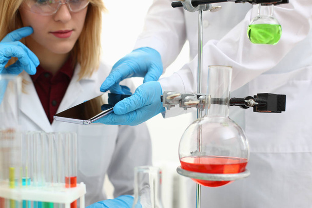 A female doctor in a chemical laboratory holds - Фото, зображення