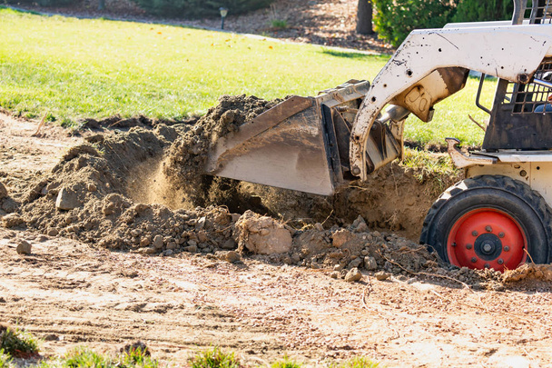 Small Bulldozer Digging In Yard For Pool Installation - Photo, Image