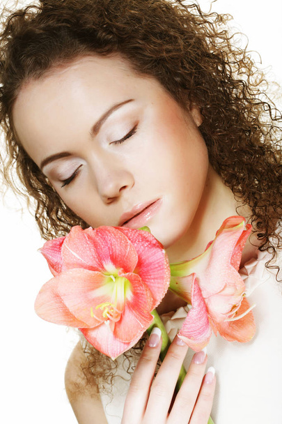 Beautiful young  woman with pink flower over white background - Φωτογραφία, εικόνα