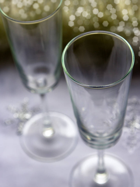 Empty champagne glasses on the table. Cooking for a festive dinner. Christmas or New Year. Festive concept. - Photo, image