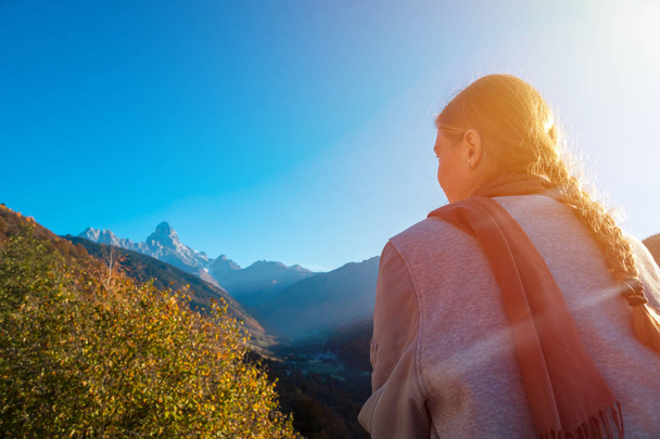 beautiful blonde girl on the background of Mount Ushba, mountains of Svaneti, Georgia. - Photo, Image