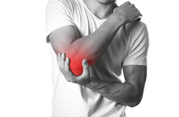 A man holding hands. Pain in the elbow. The hearth is highlighted in red. Close up. Isolated on white background. - Фото, зображення