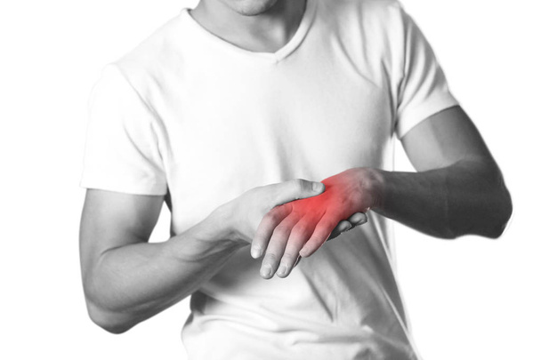 A man holding hands. Pain in the wrist. The hearth is highlighted in red. Close up. Isolated on white background. - Φωτογραφία, εικόνα