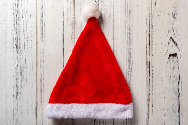 red Santa Claus hat on white wood background - Photo, Image