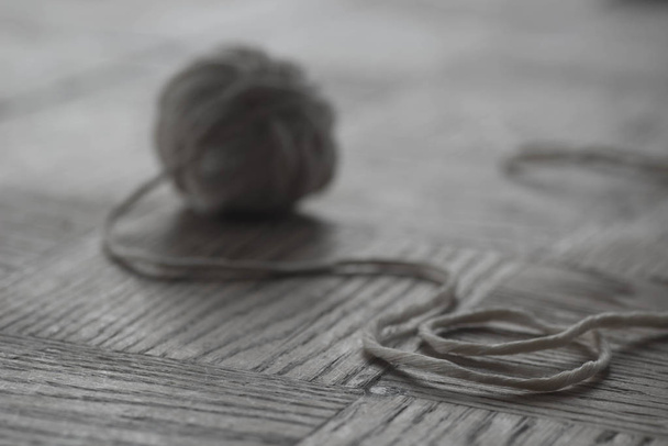 gray cotton ball of yarn on wooden  background selective focus macro - Photo, Image