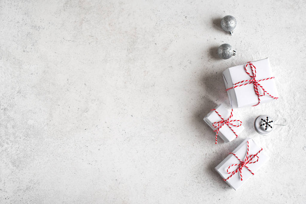Christmas Gift Boxes in white background, copy space. White Christmas Gifts and silver balls, festive composition, concept. - Φωτογραφία, εικόνα