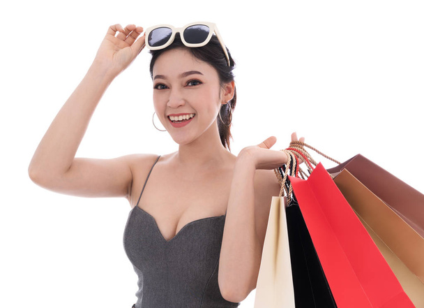 cheerful young woman holding shopping bag isolated on a white background - Foto, afbeelding