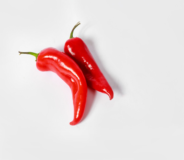 Two red peppers on white background - Φωτογραφία, εικόνα