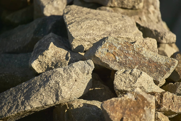 Group of rocks illuminated by the setting sun: ideal image as a background for graphic projects. - Zdjęcie, obraz