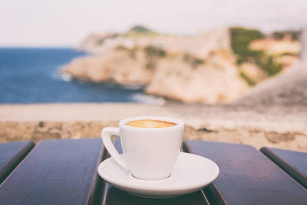 Cup of coffee on the ancient city wall of Dubrovnik Old Town view, relax cityscape background in soft light, Dalmatia, Croatia - Фото, зображення