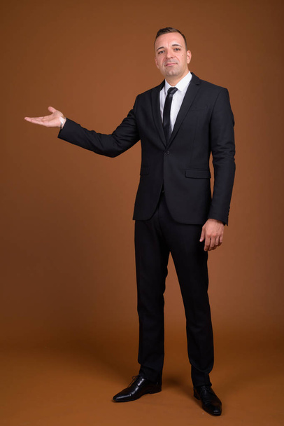 Full length shot of businessman standing and wearing suit - Fotografie, Obrázek