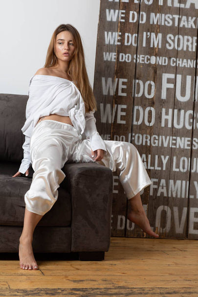 Moscow a photoshoot in studio with the charming girl. A photoshoot in a light dressing gown of white color. - Fotó, kép