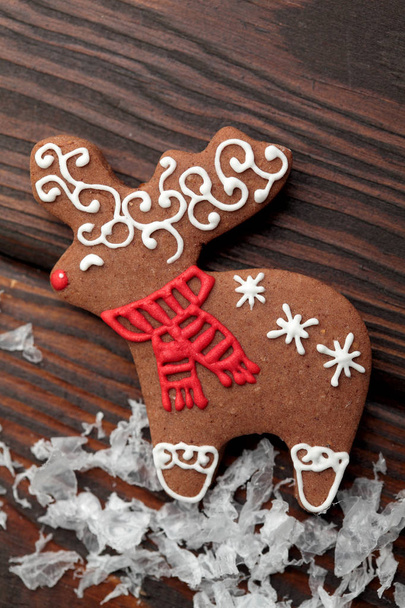 Christmas homemade gingerbread deer over wooden table.Closeup - Photo, Image