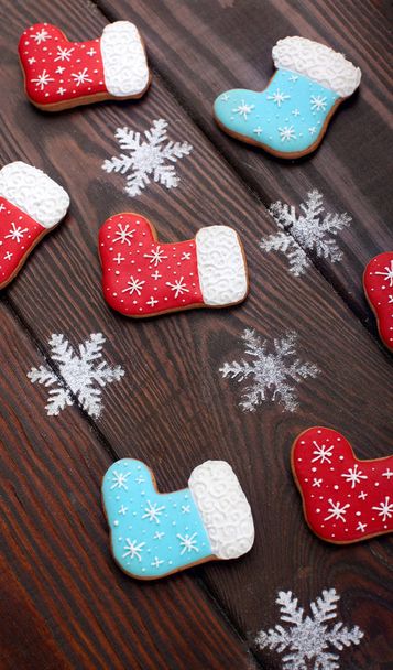 Many Gingerbread cookies boots with caramel sticks over wooden background.Sweet Background.Closeup.Christmas background - Φωτογραφία, εικόνα