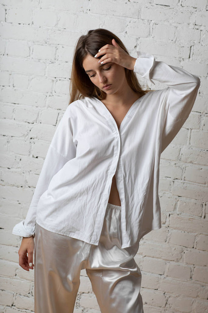 Moscow a photoshoot in studio with the charming girl. A photoshoot in a light dressing gown of white color. - Photo, Image