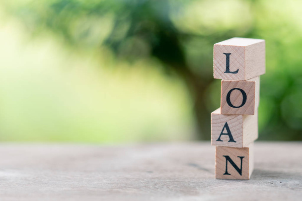 wood word LOAN standing on wood table using as background business concept and finance concept with copy space  for your text or design. - 写真・画像