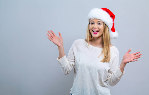 Happy woman with a Santa hat - Zdjęcie, obraz