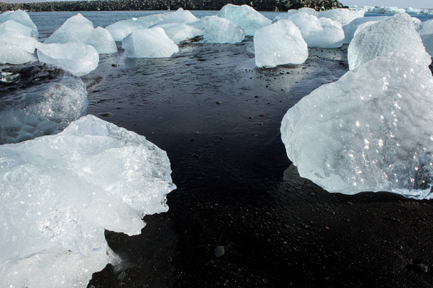 Diamond Beach Islandia. Hielo en la playa negra cerca de la laguna glaciar Jokulsarlon. Glaciar icebergs en Islandia. Naturaleza islandesa
. - Foto, Imagen