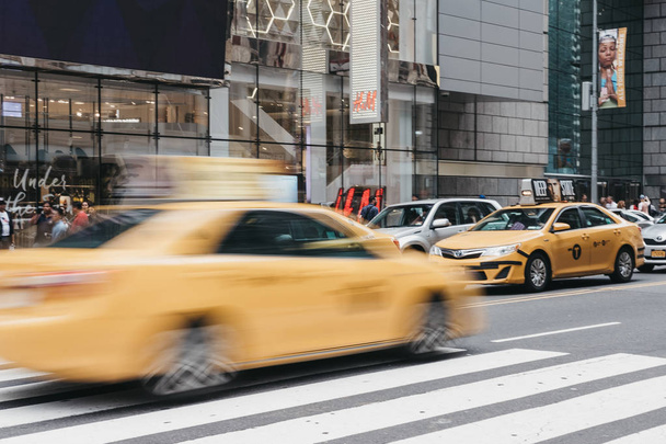 New York, USA - May 28, 2018: Yellow taxi on the street in New York, motion blurred. Yellow taxis are recognised worldwide as the icons of the city. - 写真・画像